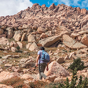 Person hiking above timberline with a backpack on